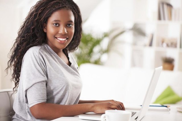 Young female student typing on laptop