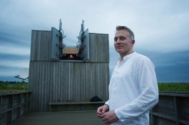 An astronomer stands outside the Kielder Observatory in England