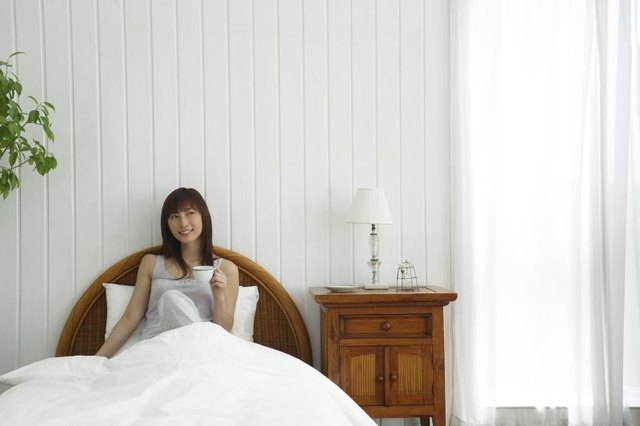 Woman in an all white bedroom