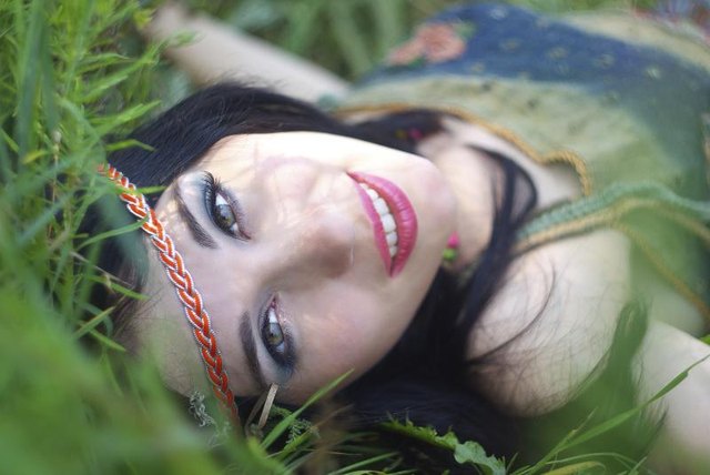 Hippie woman lying in grass