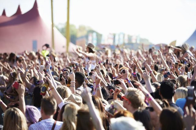Large crowd at music festival.