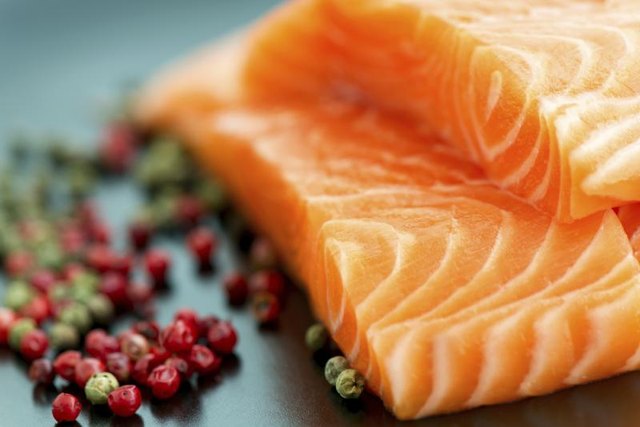 Raw salmon and some peppercorns.