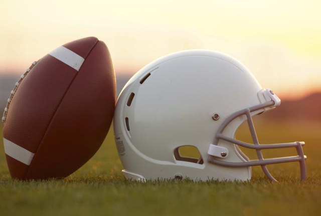 Football and helmet on field.