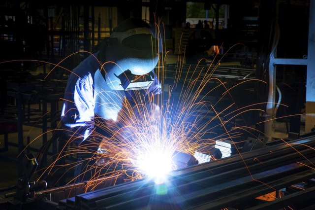 A welder works on a steal structure.