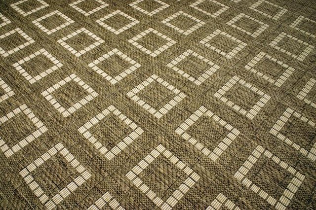 Close-up of carpet squares arranged on a floor.