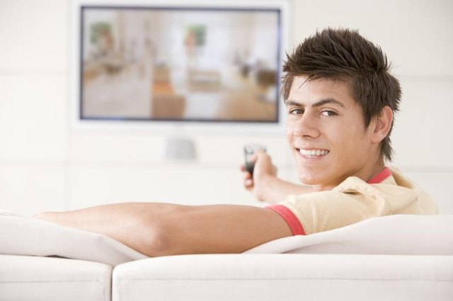 Man sitting on a sofa in front of tv