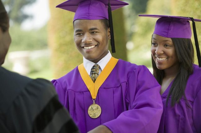 Young man receiving an award upon graduation.