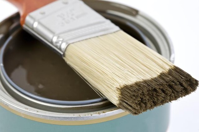 Paint brush on a brown can of paint.