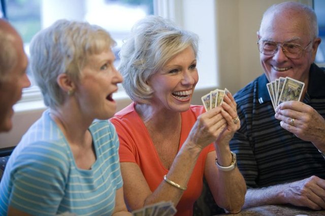 A group of friends having fun playing cards together.