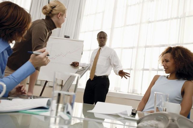 Man pointing at a chart in a business meeting Man pointing at a chart in a business meeting