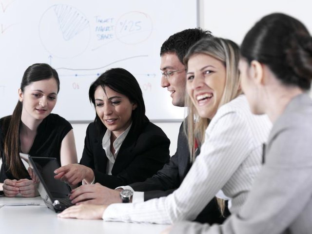 Business colleagues laughing in meeting