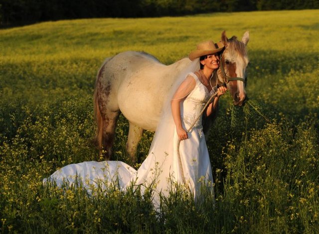 Bride with a horse in a field.