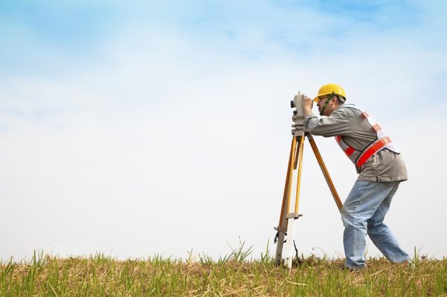 A surveyor is working outside.