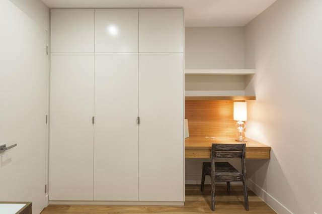 Sleek storage cabinets in a tiny home office.