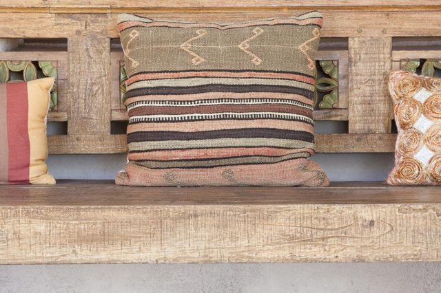 Cushions on a wood bench.