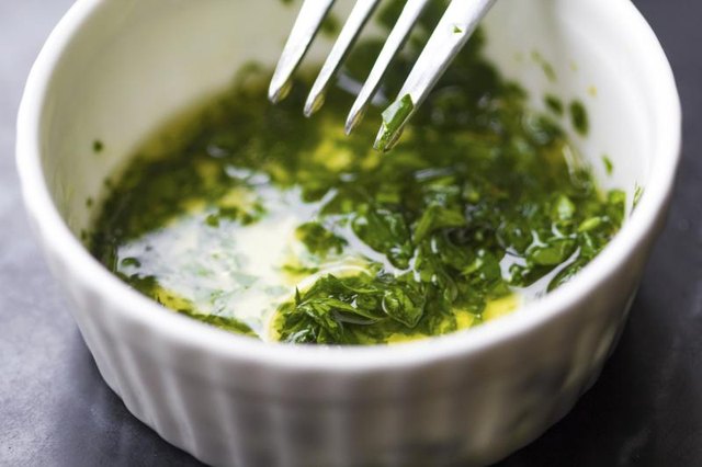 A side of fresh dressing made with garlic infused olive oil, lemon and parsley.