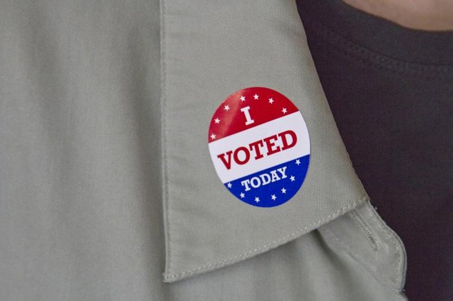 Image of a man with a voting sticker on.