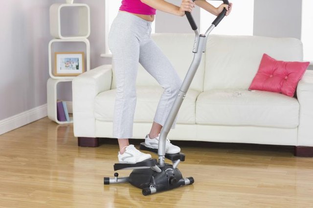 A woman is training on a step machine.