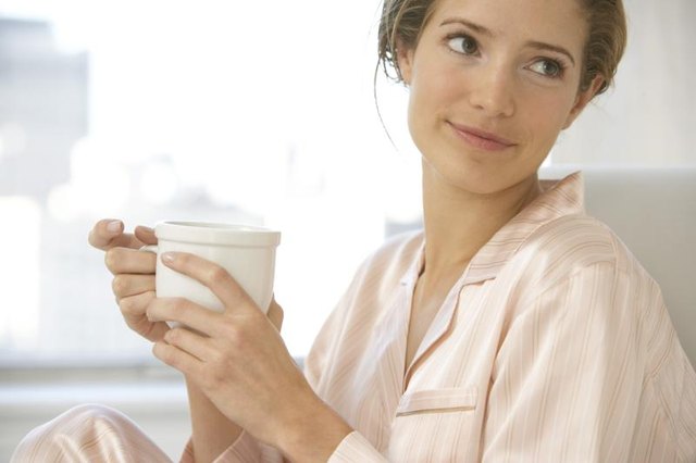 Woman holding cup of coffee.