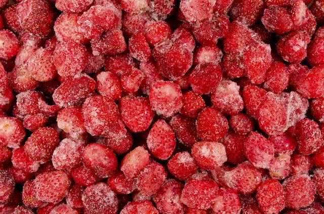 Dozens of frozen strawberries.