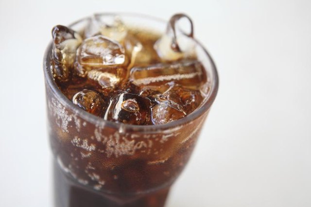 A tall glass of cola with ice.