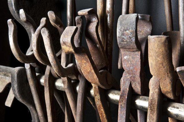 Variety of metal tongs in blacksmith forge