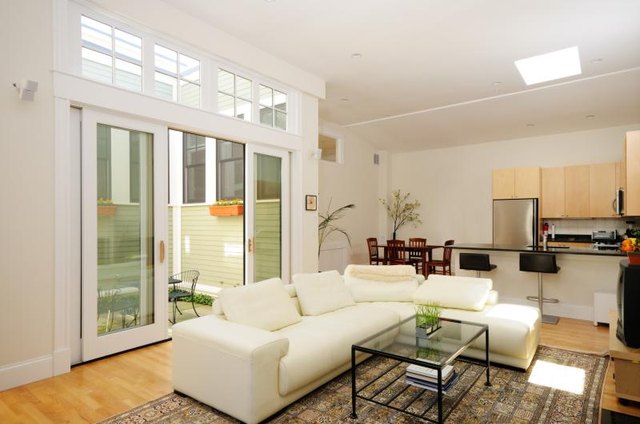 Patio doors leading to a terrace behind a sofa.