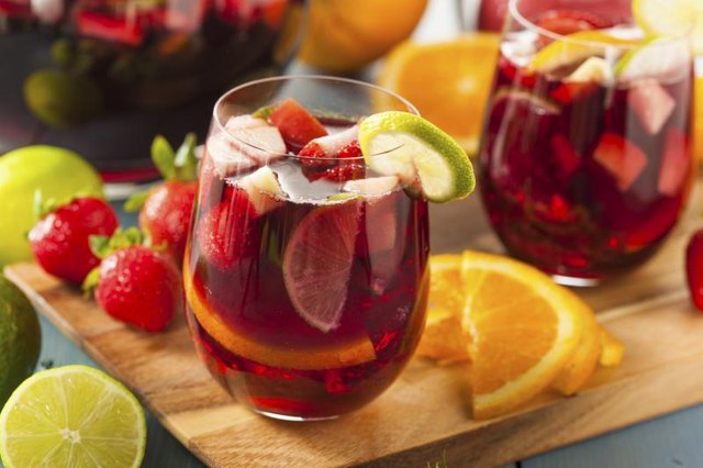 A cup of Sangria and fresh fruit.