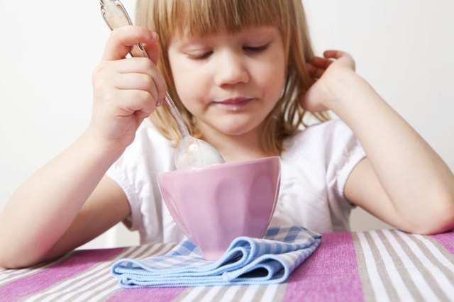 Girl eating yogurt.