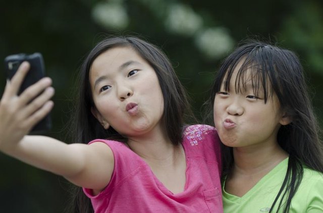Girls taking photos on a phone