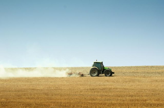 Tractor plowing a field.