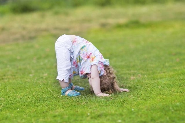 Preschooler streching in grass