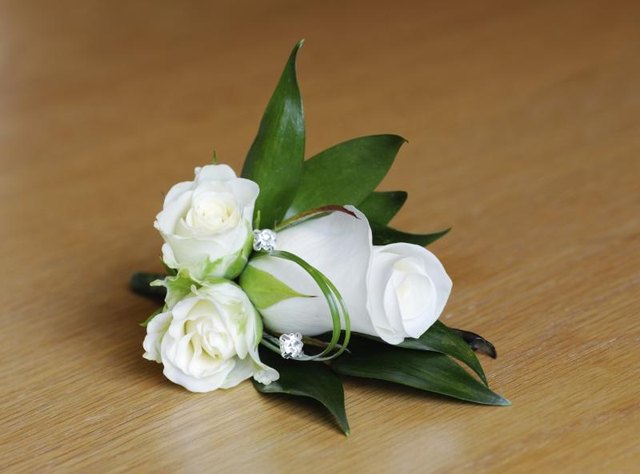 White rose corsage on table.