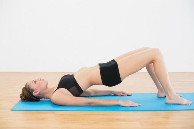 Close up of young woman holding the bridge pose
