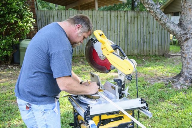 Man using a miter saw.