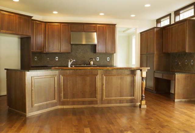 Kitchen with cherry wood cabinets and flooring