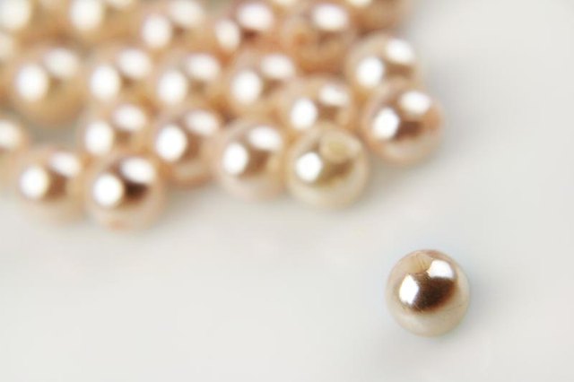 A shiny pearl on a plain background.