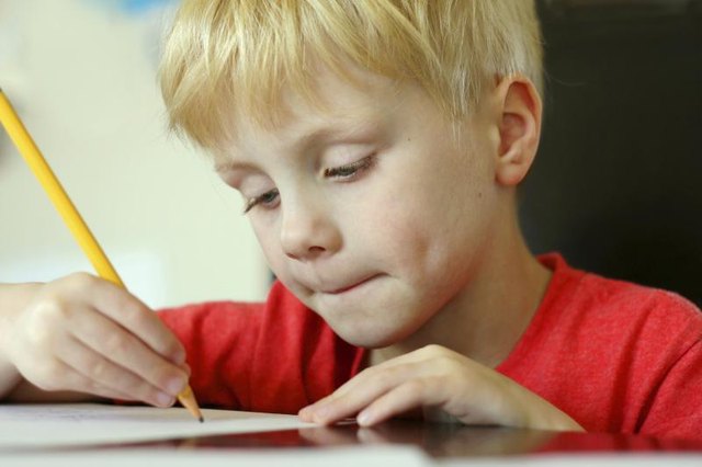 First grader using pencil to write
