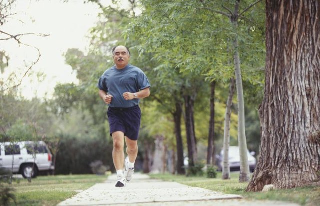 Man jogging on a sidewalk.