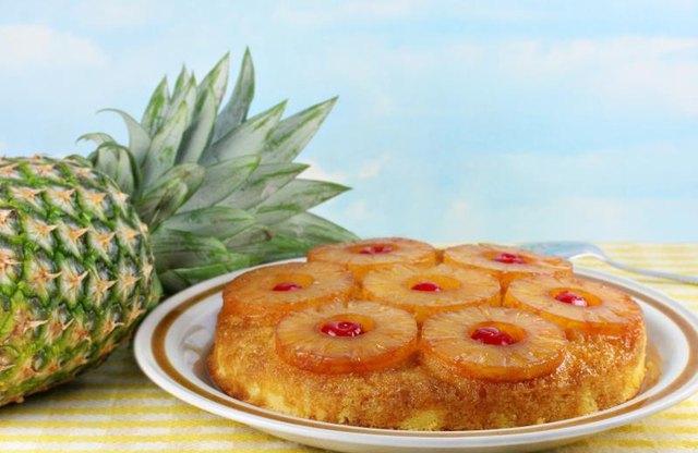 Pineapple upside down cake next to a pineapple