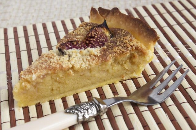 A slice of almond marzipan cream and figs pie