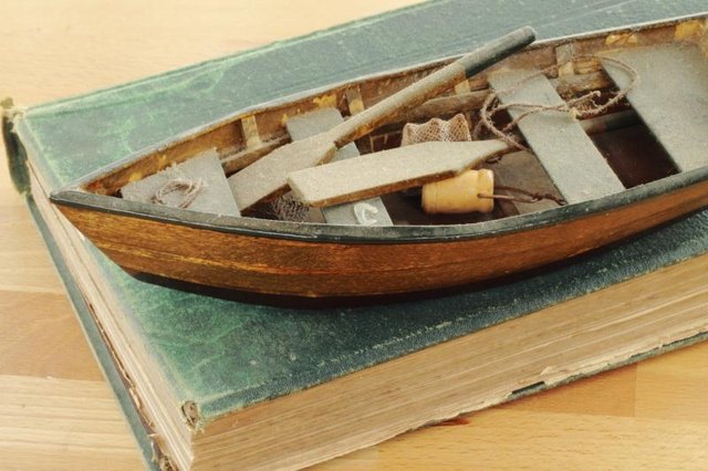 Miniature boat on a book.