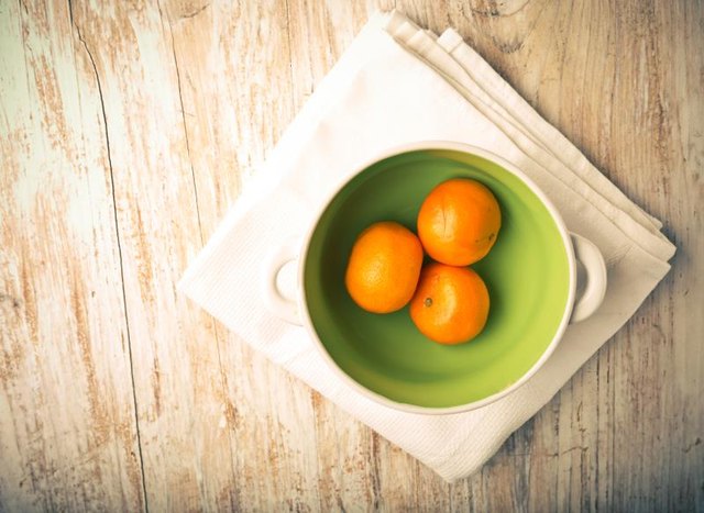 Mandarins in a green bowl