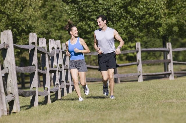 Couple jogging outside on a sunny day.