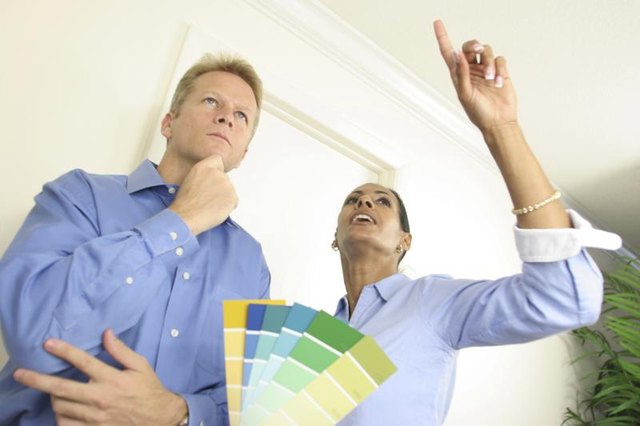 Couple looking at paint swatches, trying to decide on color