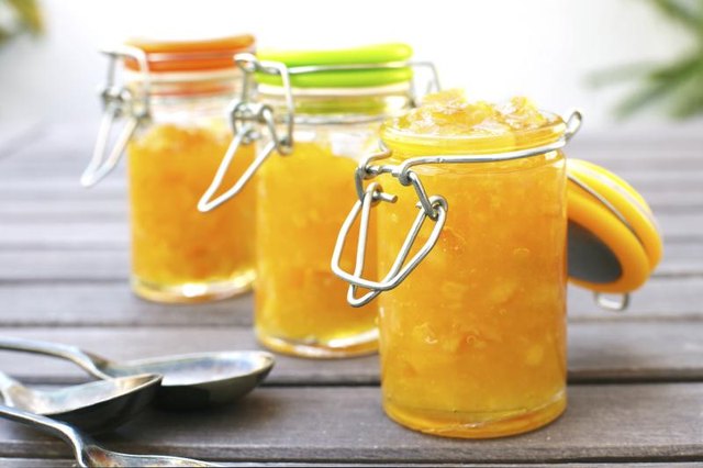 Three jars of orange chutney.