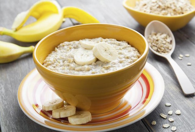 A bowl of hot instant oatmeal topped with banana slices.