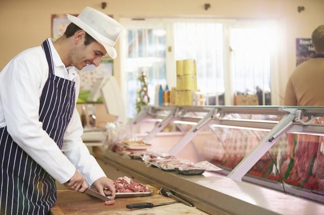 Butcher cutting meat