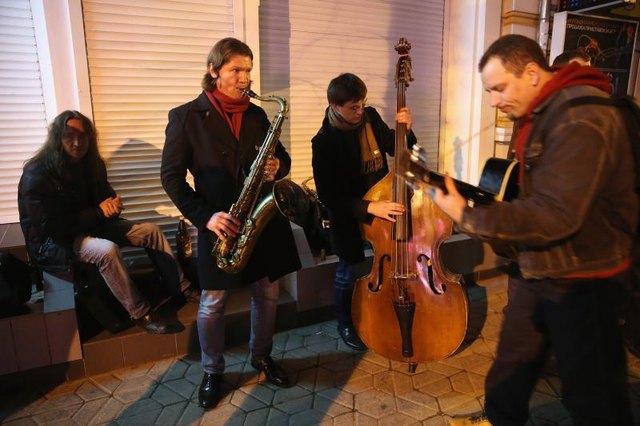 A group of jazz musicians playing in street. A group of jazz musicians playing in street.
