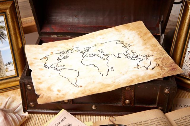 An antique map inside of a trunk.